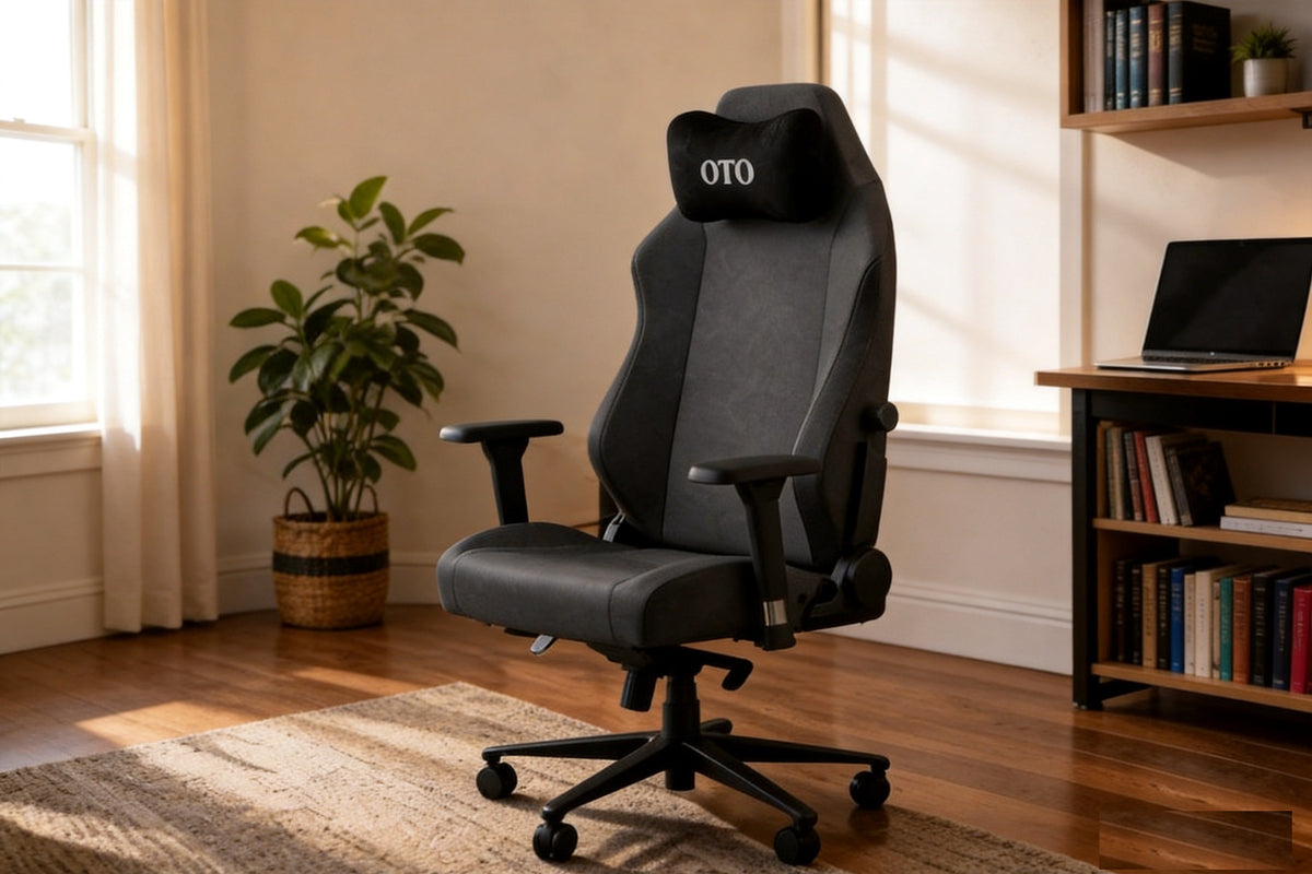 Dark grey fabric gaming chair in a warm living room with wood floor and natural window light.